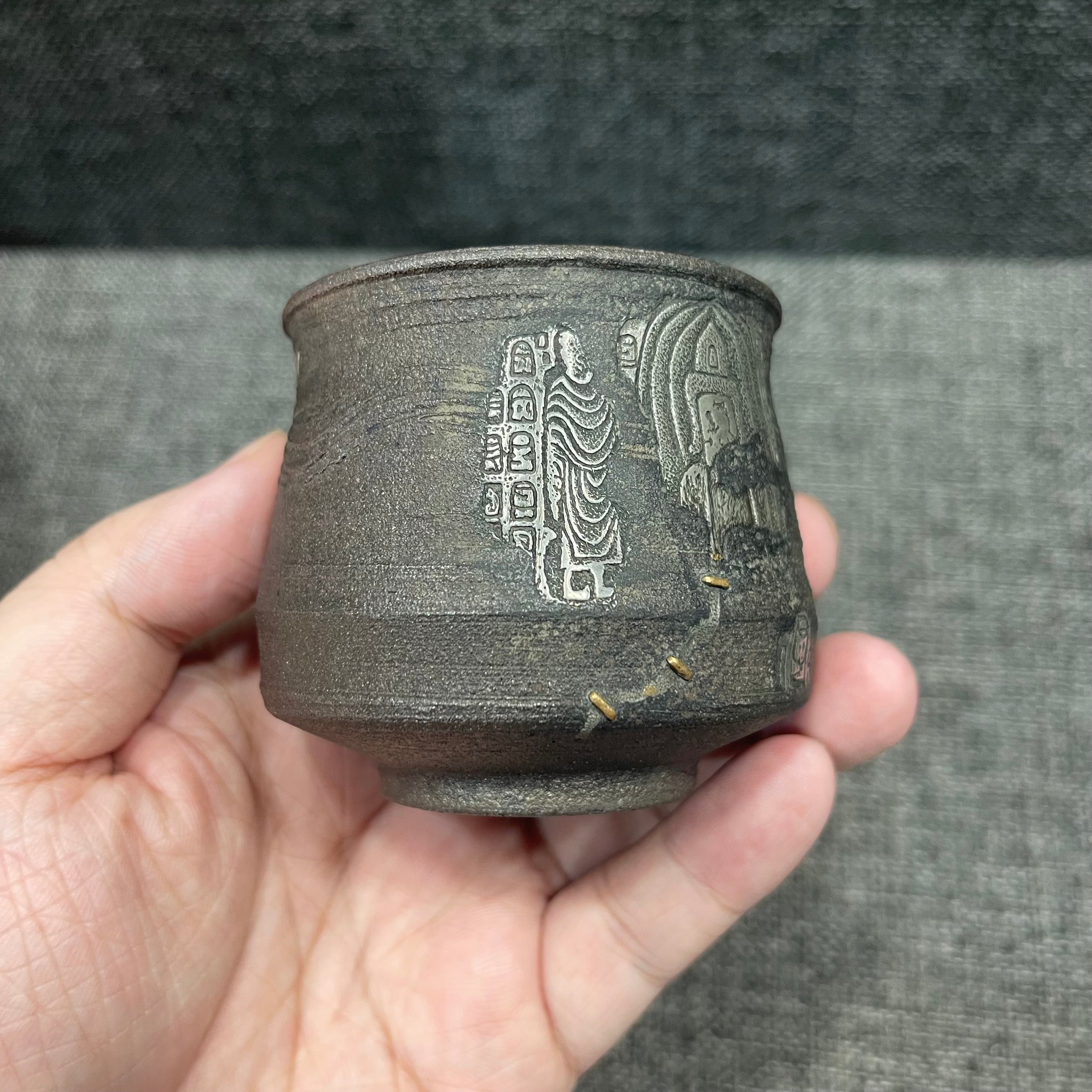 Jianzhan is naturally fired with ash, using a wood-fired kiln. Hand-carved tin sculptures of Buddha statues from Dunhuang