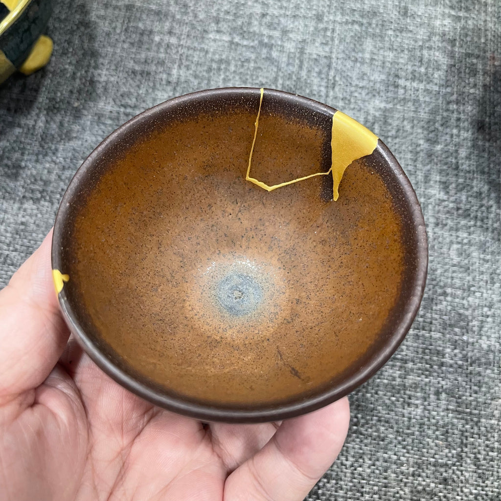Song Dynasty persimmon-red glaze bell-shaped cup, restored with gold repair technique, Jianzhan tea cup