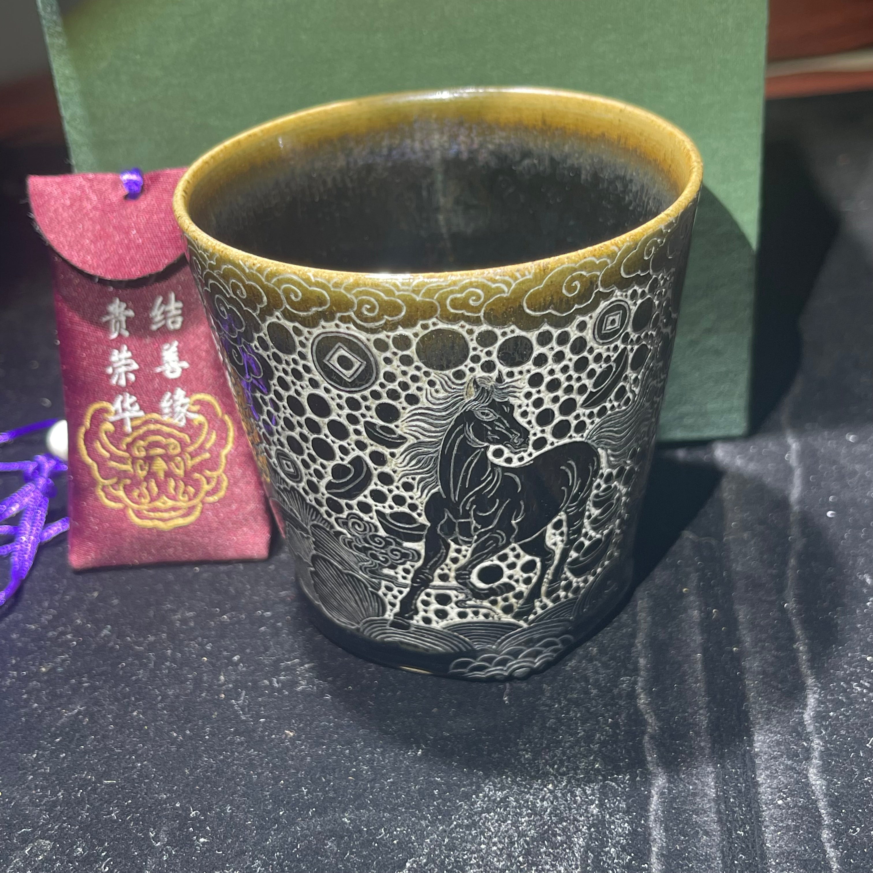 Jianzhan Coke cup with a galloping horse and a pattern of wealth coming from all directions.