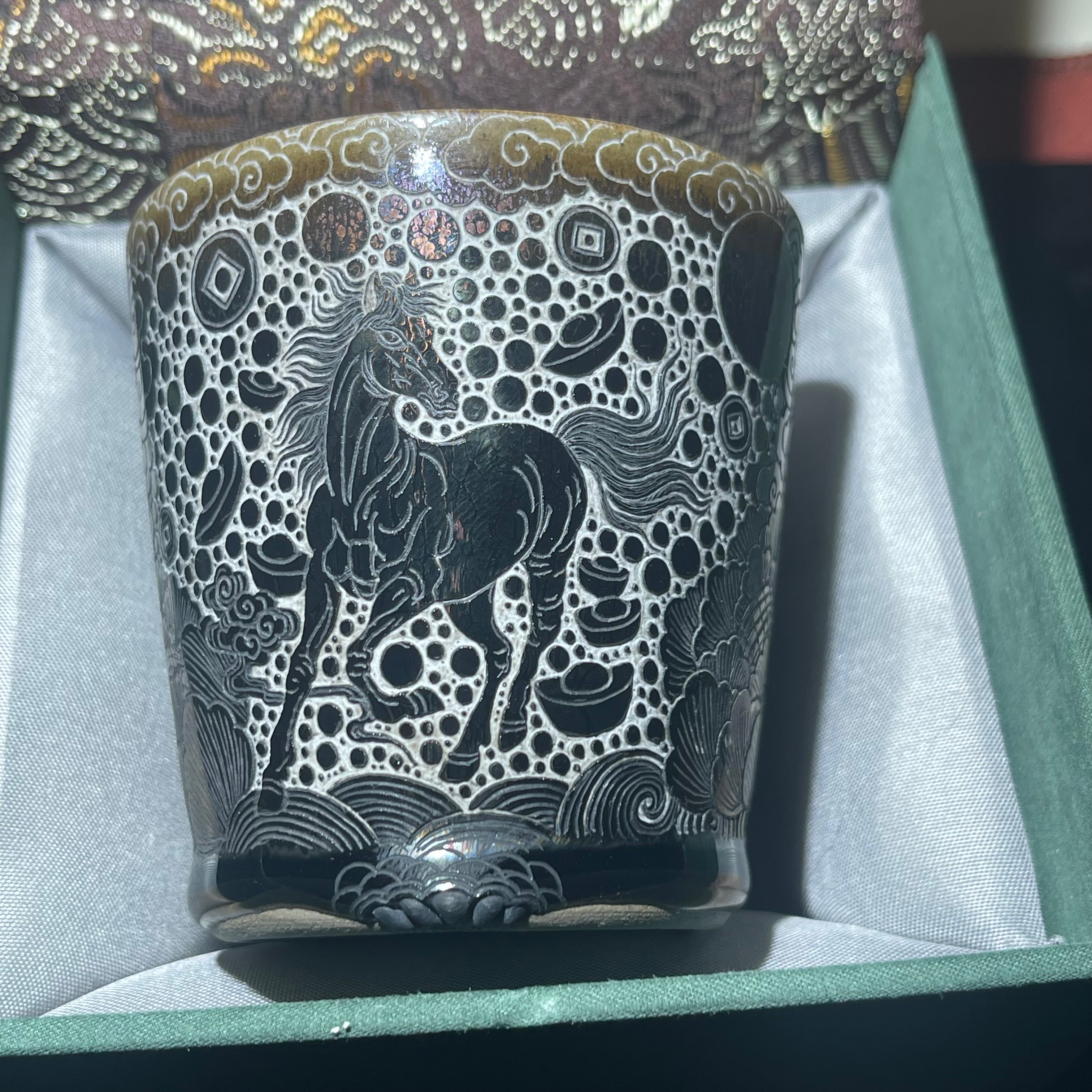 Jianzhan Coke cup with a galloping horse and a pattern of wealth coming from all directions.