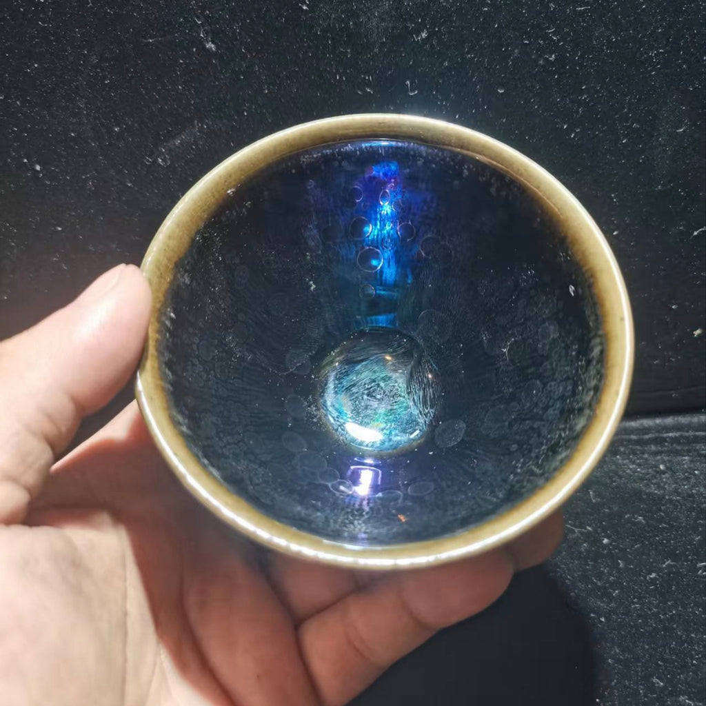 Dancing lion with water wave patterns carved on the base. Hand-carved Jianzhan tea cup
