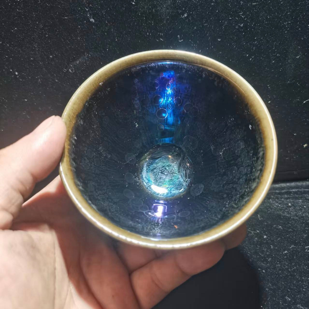 Dancing lion with water wave patterns carved on the base. Hand-carved Jianzhan tea cup