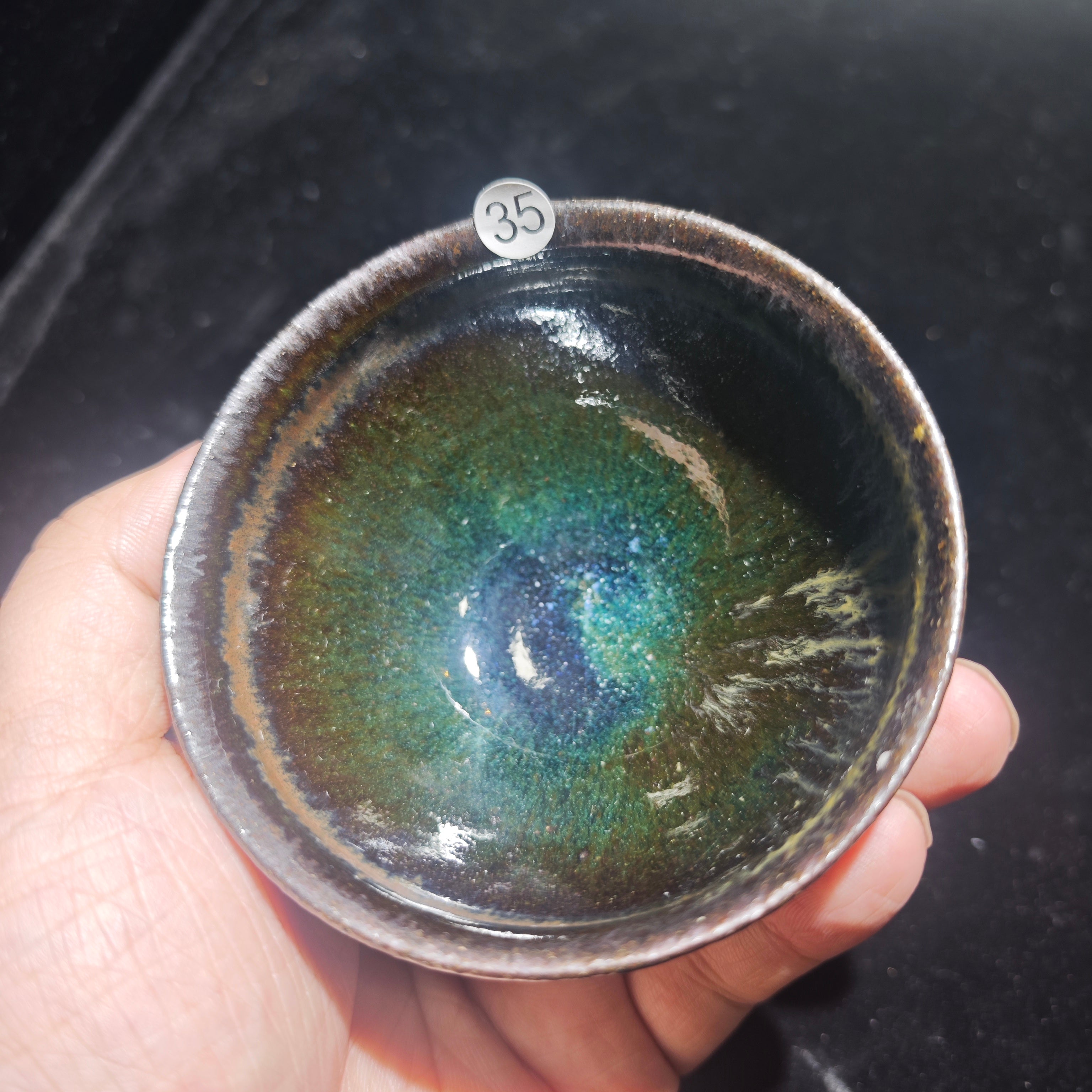 Ink jade ash-burned Jianzhan teacup, hand-carved with wave patterns