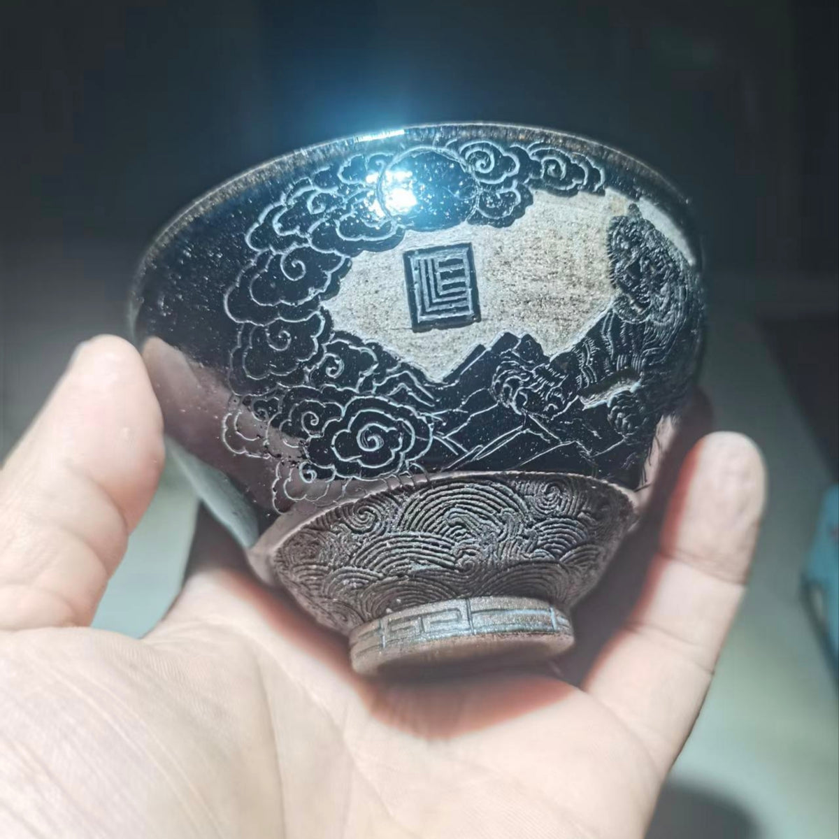 Tiger Descending the Mountain, hand-carved black-glazed teacup