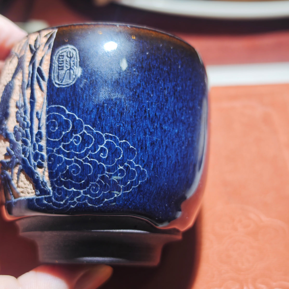 A magpie perched on a branch - a beautiful symbol. Jianzhan tea cup carving