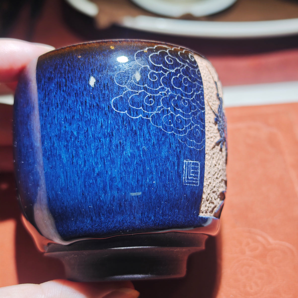 A magpie perched on a branch - a beautiful symbol. Jianzhan tea cup carving