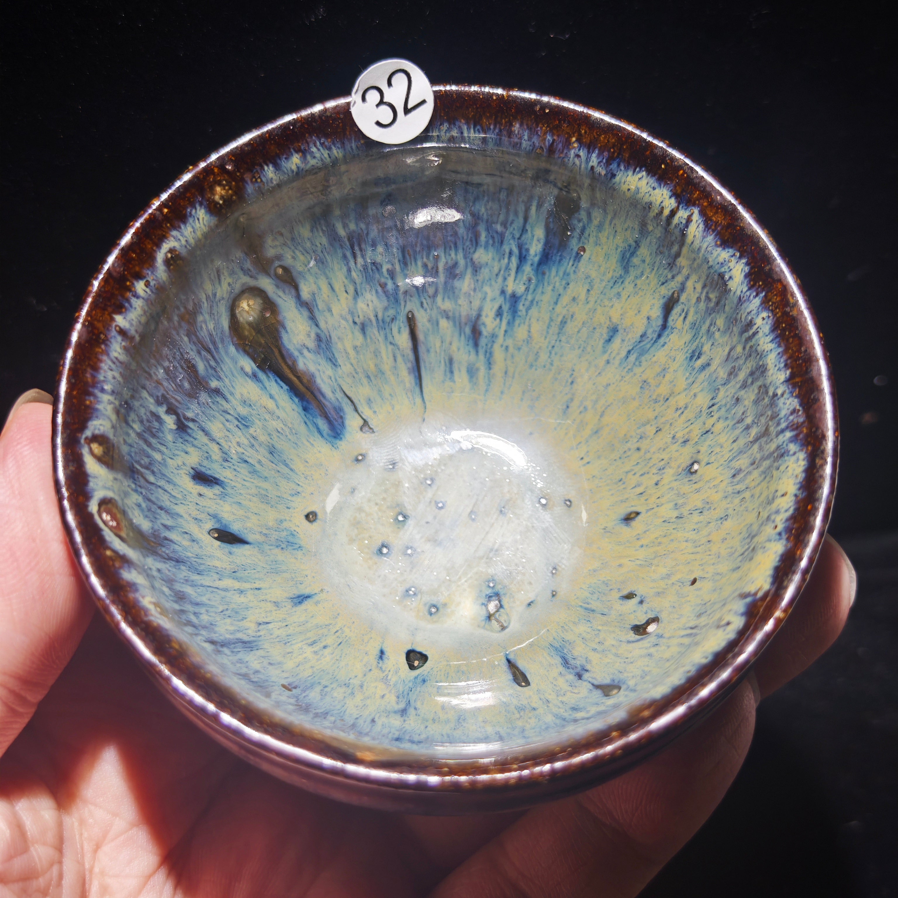 Ash-burned Jianzhan tea cup with animal claw foot and dragon carving, handmade craft