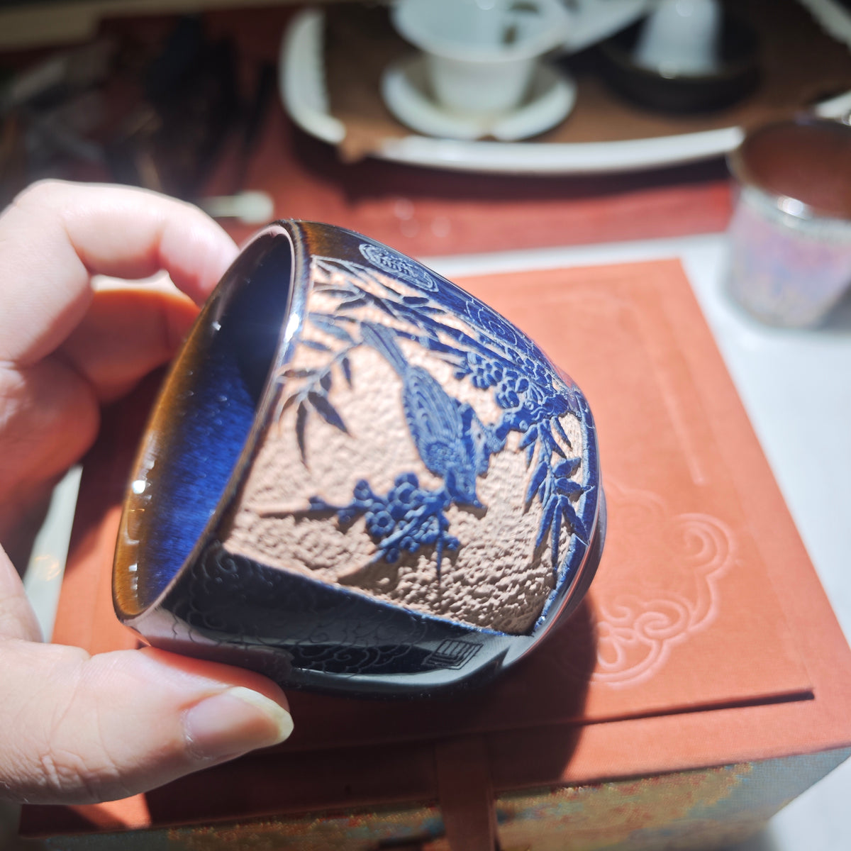 A magpie perched on a branch - a beautiful symbol. Jianzhan tea cup carving
